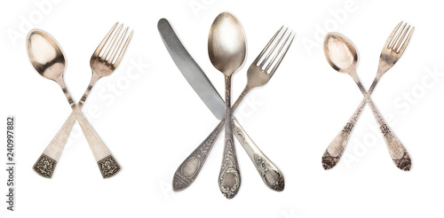 3 set crossed vintage spoon,knife and fork isolated on old vintage background. Rustic style