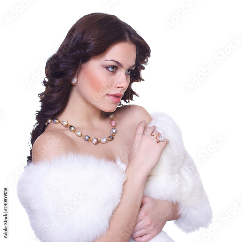 Portrait of a young beautiful brunette girl in a white fur collarover