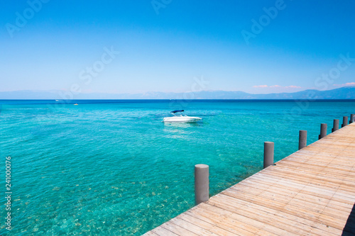Idyllic water scene with wooden dock and Lake Tahoe and boat