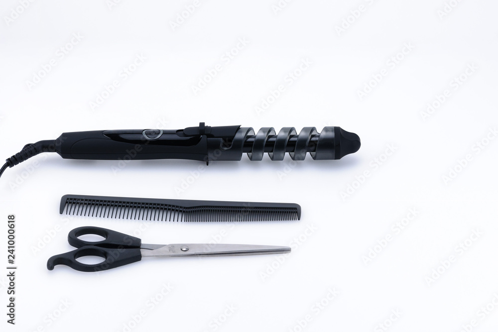 Grey hair iron with accessory on the white background with copy space. Grey hair iron with accessory on the white background with copy space.
