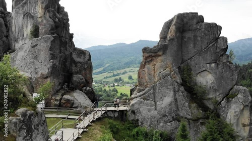 Rock Formations In Mountains. People Traveling In Nature photo