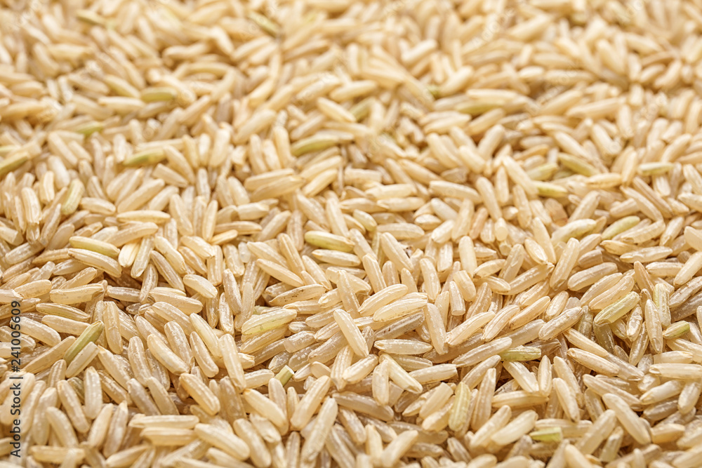 Pile of raw unpolished rice as background, closeup Pile of raw unpolished rice as background, closeup