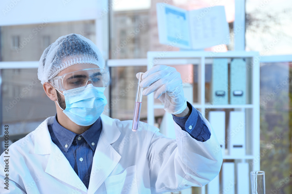 Young scientist working with test tube in laboratory. Chemical analysis Young scientist working with test tube in laboratory. Chemical analysis