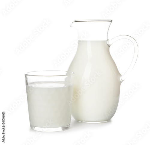 Glass and jug with fresh milk on white background