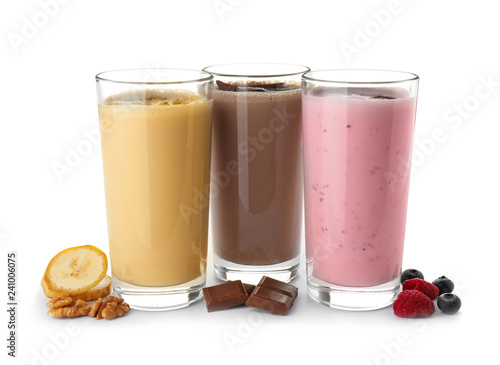 Glasses with different protein shakes and ingredients isolated on white