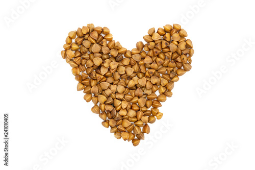 Buckwheat groats, heart-shaped, close up, isolated. Gluten free and non-allergenic healthy diet food. Used as source of Vegetarian Protein and improved heart health. photo