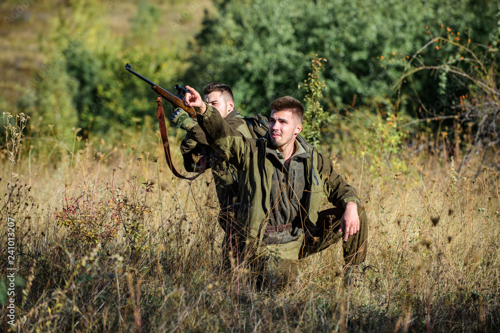 Hunter friend enjoy leisure in field. Hunters gamekeepers looking for animal or bird. Hunting with friends hobby leisure. Hobby for real men concept. Hunters with rifles in nature environment Hunter friend enjoy leisure in field. Hunters gamekeepers looking for animal or bird. Hunting with friends hobby leisure. Hobby for real men concept. Hunters with rifles in nature environment