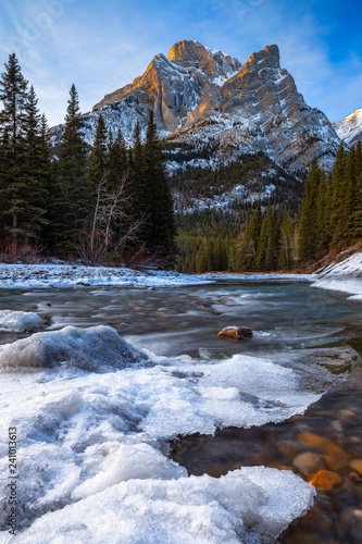 Mount Kidd, a mountain in Kananaskis in the Canadian Rocky Mountains, Alberta, Canada and the Kananaskis River in winter