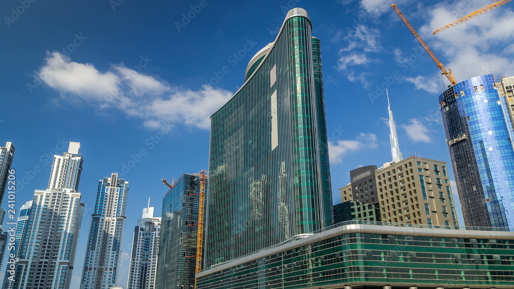 Scenic skyline of Dubai's business bay with skyscrapers at day time timelapse.