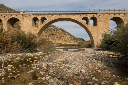 old stone bridge across the river, province of almeria, region of andalucia, spain © ffmr