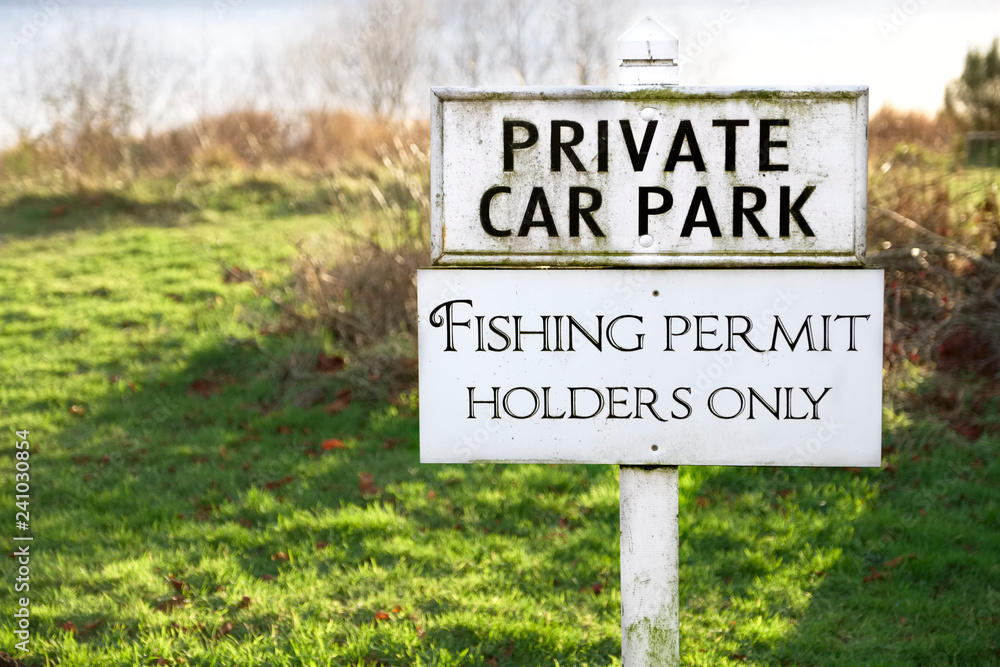 Fishing permit holders only sign post and private car park