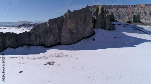 Wallpaper Mural Flying towards and over rocky cliff viewing desert landscape in winter on sunny day in the Utah Badlands. Torontodigital.ca