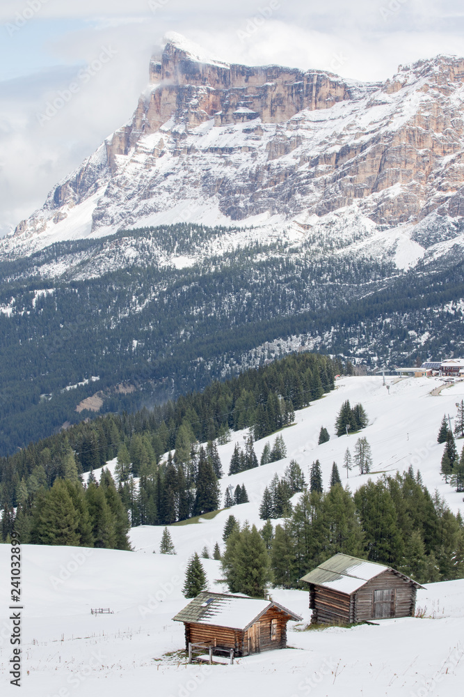 Fototapeta premium Pralongià, Italy - August 25, 2018: Alpine landscape with snowy meadows and huts