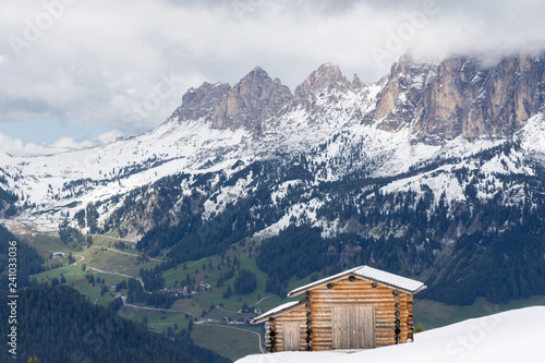Pralongià, Italy - August 25, 2018: Alpine landscape with snowy meadows and huts