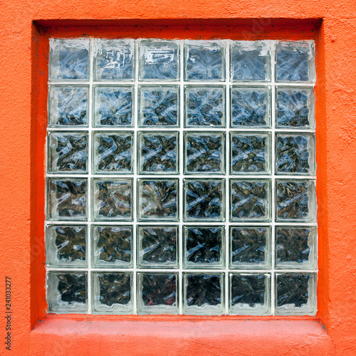 Glass block window with orange frame trim.