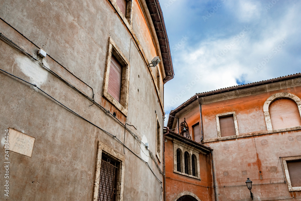 A view of Piazza Dante. Ancient building with arch, three windows and bell. Anagni, Frosinone, Italy. A view of Piazza Dante. Ancient building with arch, three windows and bell. Anagni, Frosinone, Italy.