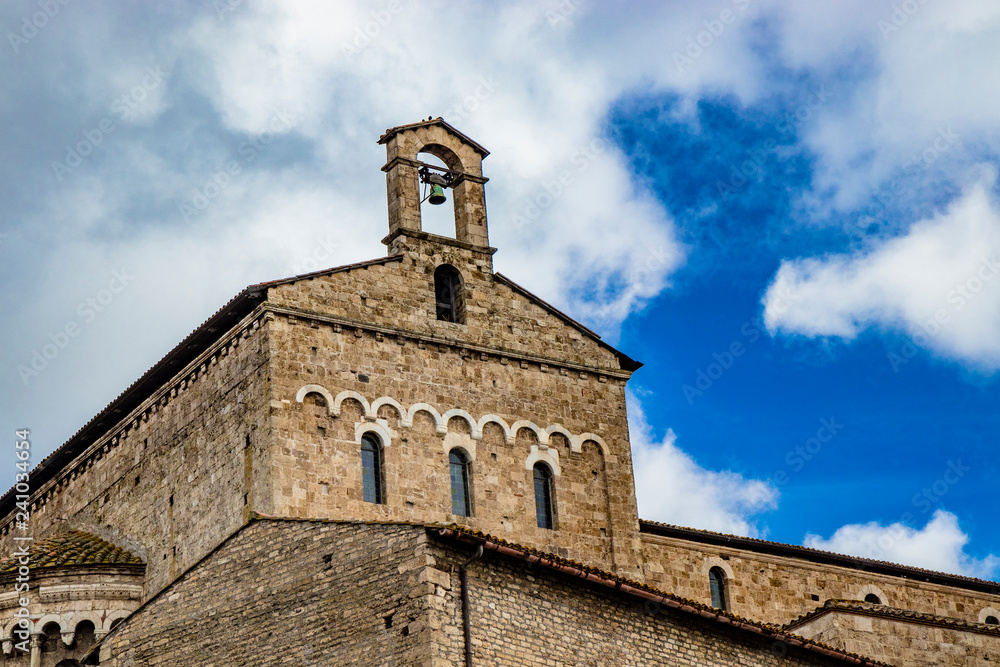 exterior of the transept with white stone arches, of the cathedral Basilica of Santa Maria Annunziata, in Romanesque style. Anagni, Frosinone, Italy.