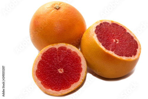 Pink ripe grapefruit slice on white isolated background. Half and slice of grapefruit isolated on white.