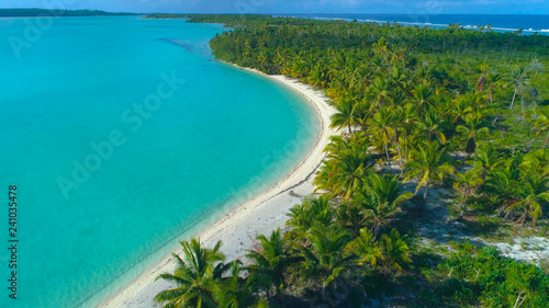 DRONE Calm turquoise ocean washing the untouched sandy coast of tropical island.