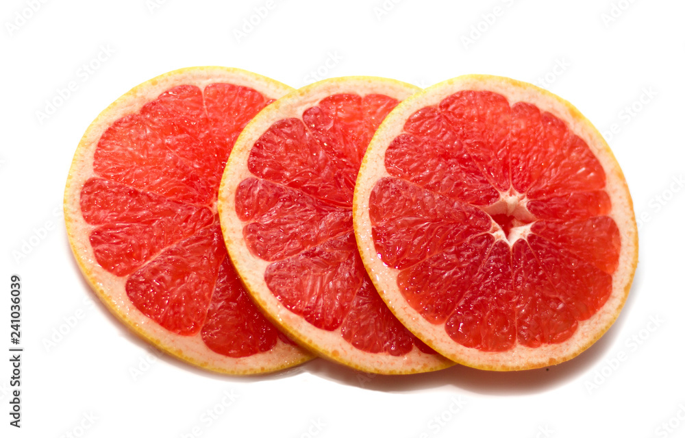 Pink ripe grapefruit slice on white isolated background. Half and slice of grapefruit isolated on white. Pink ripe grapefruit slice on white isolated background. Half and slice of grapefruit isolated on white.