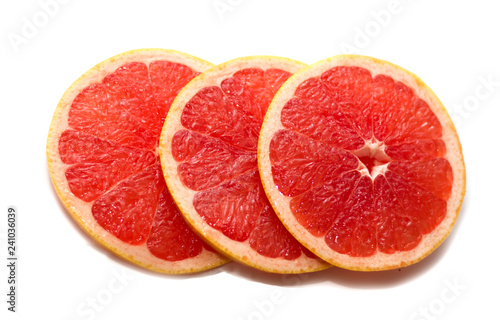 Pink ripe grapefruit slice on white isolated background. Half and slice of grapefruit isolated on white.