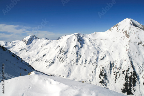 Winter landscape with hills covered with snow at Pirin Mountain, view from Todorka peak, Bulgaria