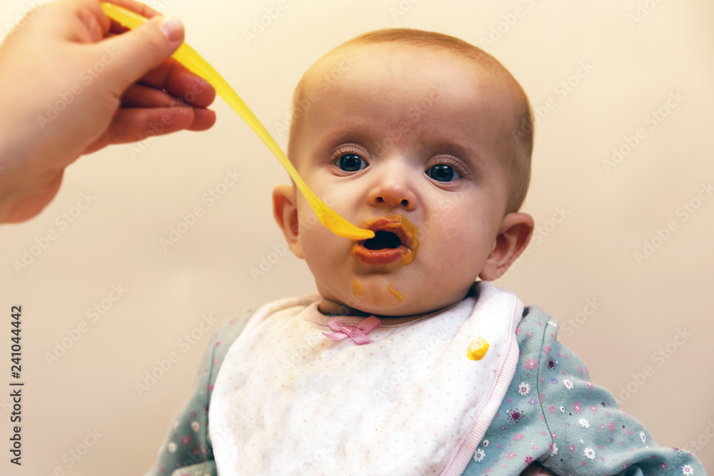 Adult Feeding Baby - Stock Image / Baby, Eating, spoon, Human Hand, One Parent Adult Feeding Baby - Stock Image / Baby, Eating, spoon, Human Hand, One Parent