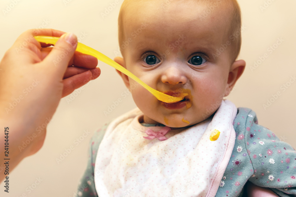 Adult Feeding Baby - Stock Image / Baby, Eating, spoon, Human Hand, One Parent Adult Feeding Baby - Stock Image / Baby, Eating, spoon, Human Hand, One Parent