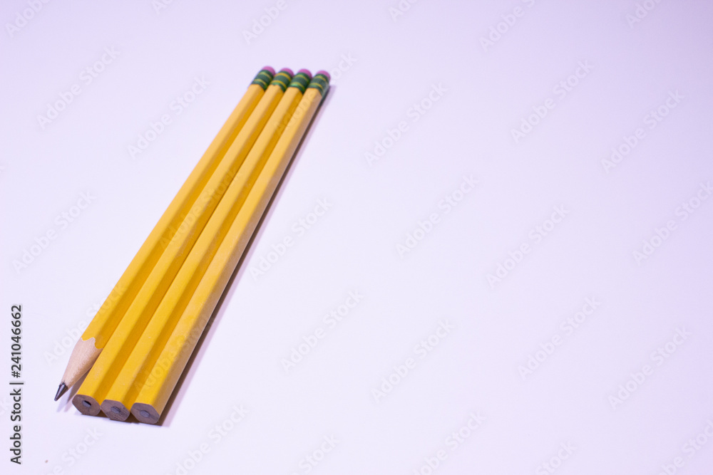 Fototapeta premium Shapened and unsharpened pencils on white background with copy space