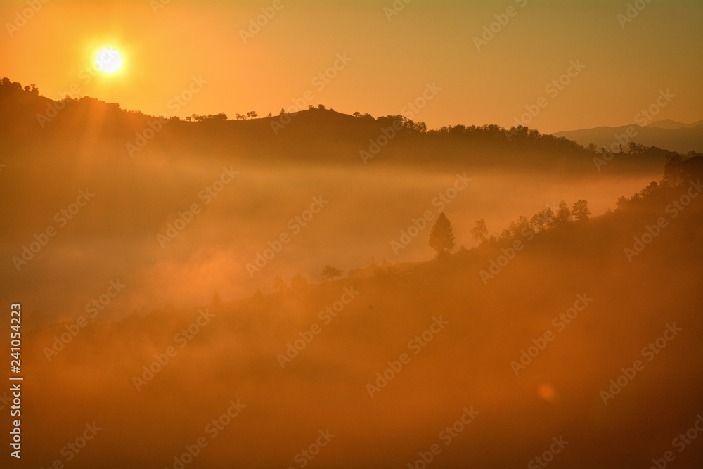 the morning autumn landscape with fog Holbav,Romania the morning autumn landscape with fog Holbav,Romania