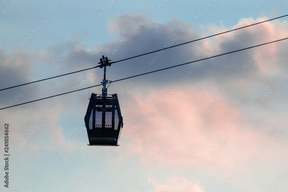 Cable car going downhill for skiers.