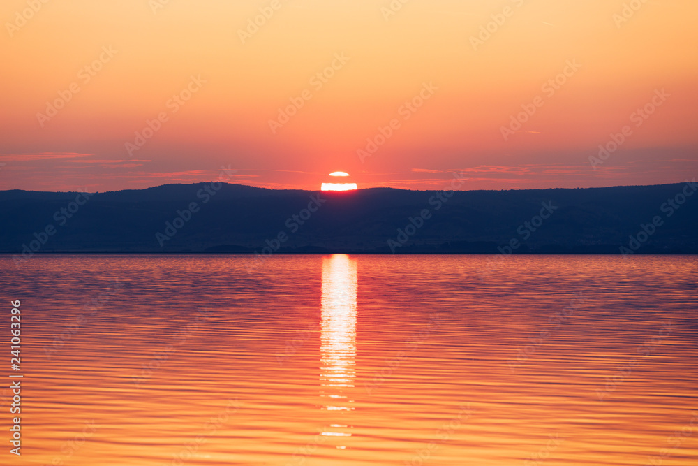 Fototapeta premium Beautiful sunset or sunrise above the sea. Tropical sunset or sunrise over sea. Colourful sunset or sunrise over water.