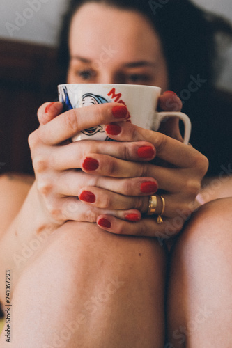 woman applying nail polish on her fingers
