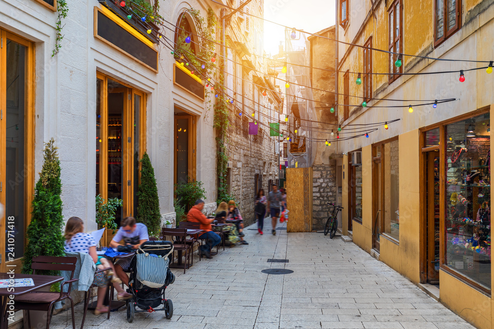 Naklejka premium Street in Split historical center, Croatia. Beautiful square of the old town of Split in Croatia. Old stone street of Split historic city, Dalmatia, Croatia
