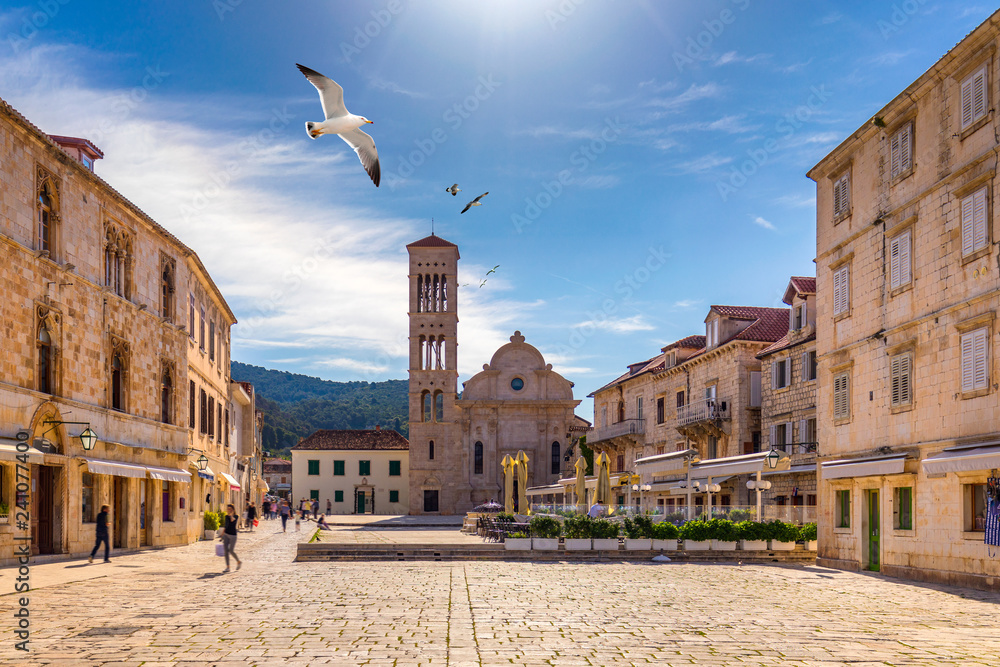 Main square in old medieval town Hvar with seagull's flying over. Hvar is  one of most popular tourist destinations in Croatia in summer. Central  Pjaca square of Hvar town, Dalmatia, Croatia. Stock