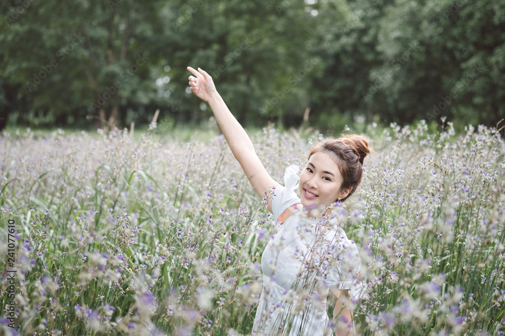 Woman with the white dress in the middle of the meadow with violet flowers Murdannia Giganteum in Prachinburi, Thailand. Photographer in nature. Woman with the white dress in the middle of the meadow with violet flowers Murdannia Giganteum in Prachinburi, Thailand. Photographer in nature.