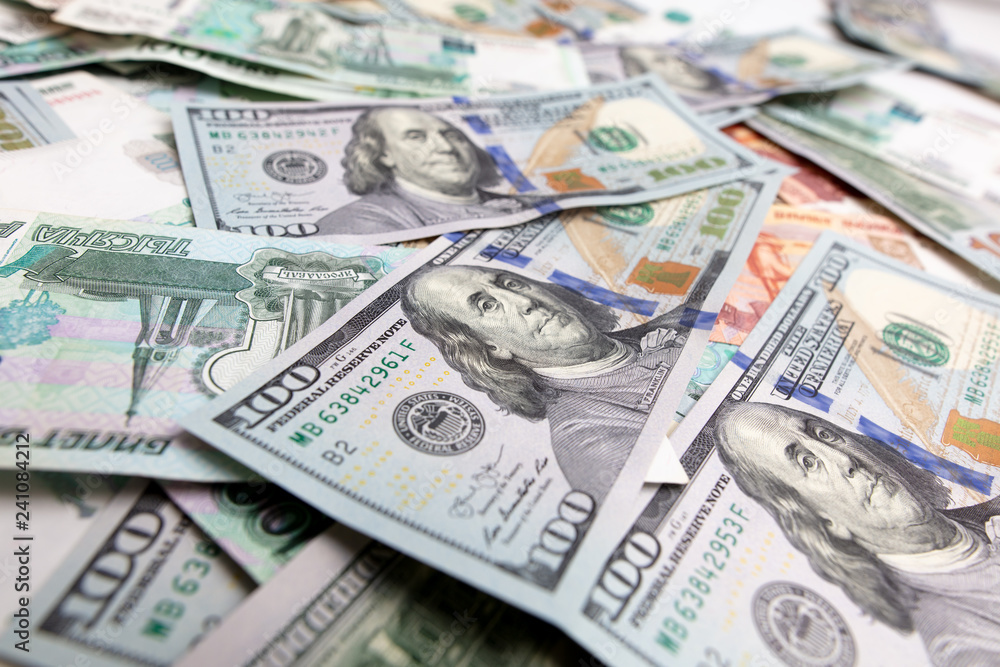 Dollars and Russian rubles on the table as background Dollars and Russian rubles on the table as background