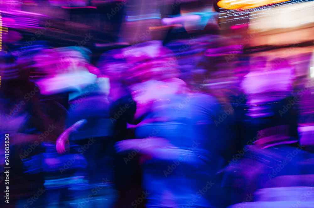 Dancing people in a disco, nightclub. People relaxing and having fun. Blur photo. Long shutterspeed