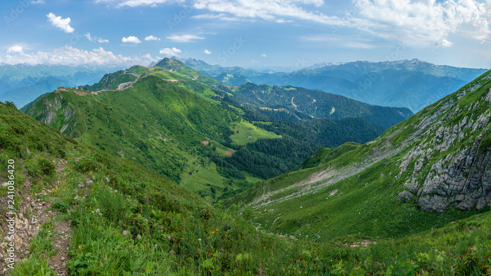 View over the Green Valley, surrounded by high mountains on a clear summer day