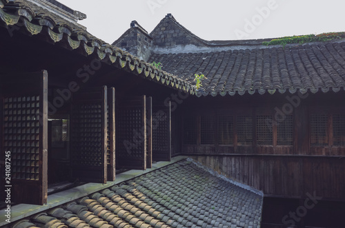Traditional Chinese houses with windows and rooftops with black roof tiles, in the old town of Xitang, China photo