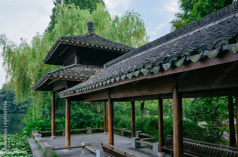 Traditional Chinese pavilion by water covered with lotus leaves, at West Lake, Hangzhou, China Traditional Chinese pavilion by water covered with lotus leaves, at West Lake, Hangzhou, China