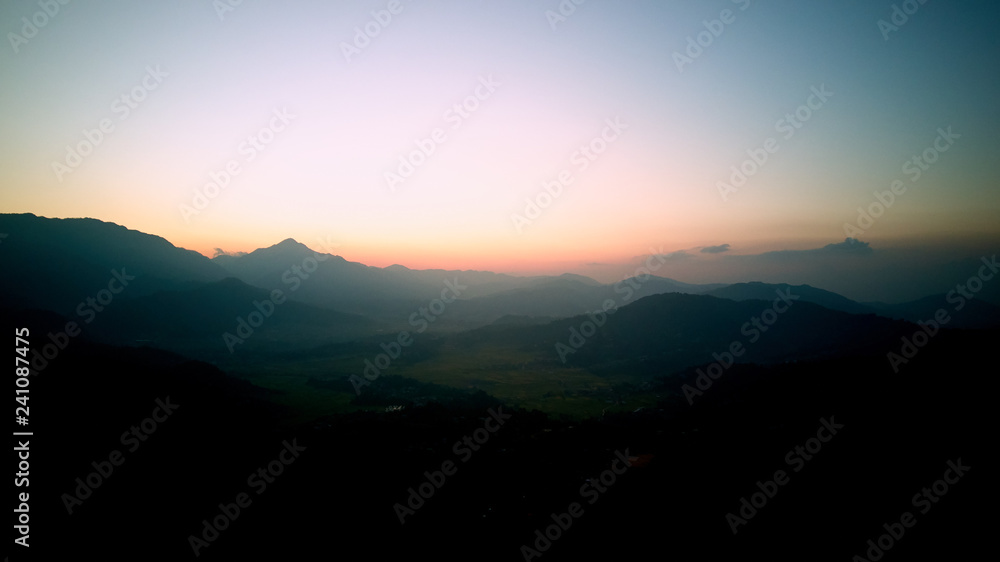 Orange sunrise above mountain in valley Himalayas mountains