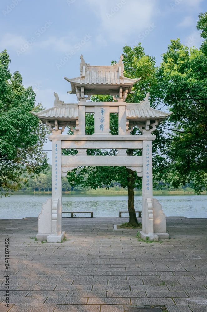 A paifang, a traditional Chinese arch, near water, in the Maojiabu area of West Lake, Hangzhou, China A paifang, a traditional Chinese arch, near water, in the Maojiabu area of West Lake, Hangzhou, China