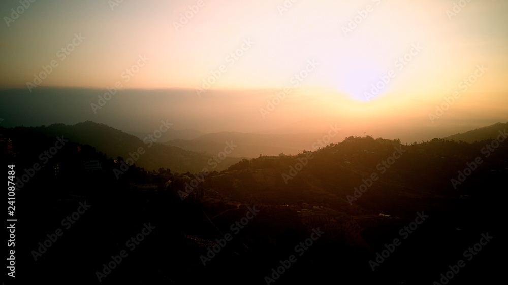 Orange sunrise above mountain in valley Himalayas mountains