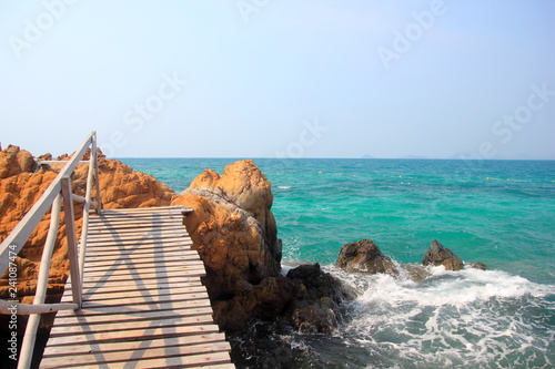 Koh kham small island and wood bridge on the beach with blue sky and clear water. Koh kham pattaya thailand.  photo