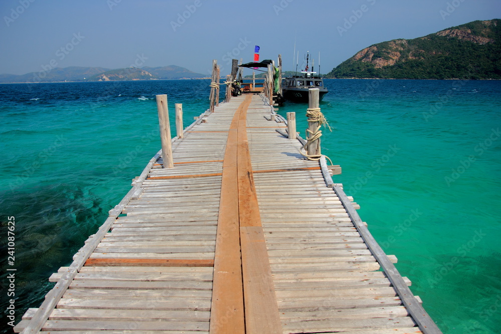 Koh kham small island and wood bridge on the beach with blue sky and clear water. Koh kham pattaya thailand. 