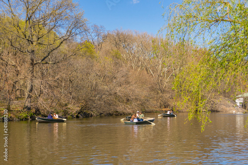 People boating in The lake at Central Park on nice weather day in New York City,USA