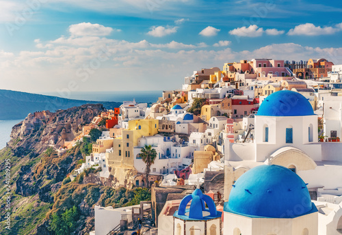 Churches in Oia, Santorini island in Greece, on a sunny day. Scenic travel background.