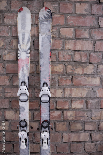 Ski.Mountain skiing standing at the brick wall. Waiting and preparing for skiing.