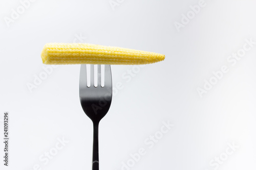Mazorca de maíz baby pinchada en un tenedor